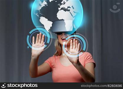 technology, virtual reality, cyberspace, entertainment and people concept - happy young woman with virtual reality headset or 3d glasses at home looking at world globe projection