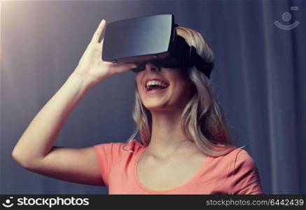 technology, virtual reality, cyberspace, entertainment and people concept - happy young woman with virtual reality headset or 3d glasses at home. woman in virtual reality headset or 3d glasses
