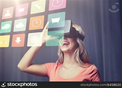 technology, virtual reality, cyberspace, entertainment and people concept - happy young woman with virtual reality headset or 3d glasses at home looking at menu icons projection. woman in virtual reality headset or 3d glasses