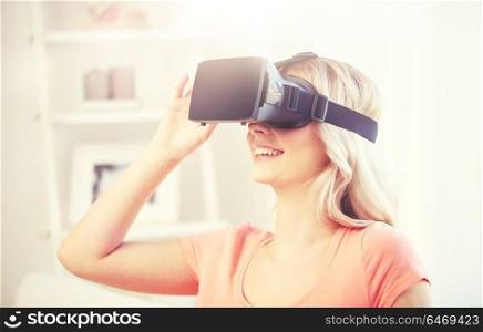 technology, virtual reality, cyberspace, entertainment and people concept - happy young woman with virtual reality headset or 3d glasses at home. woman in virtual reality headset or 3d glasses