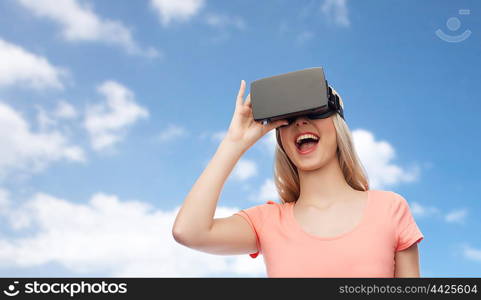 technology, virtual reality, entertainment and people concept - happy young woman with virtual reality headset or 3d glasses over blue sky and clouds background