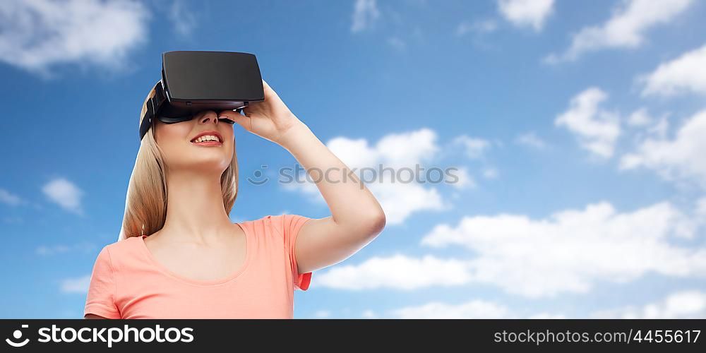 technology, virtual reality, entertainment and people concept - happy young woman with virtual reality headset or 3d glasses over blue sky and clouds background