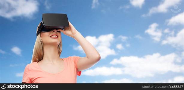 technology, virtual reality, entertainment and people concept - happy young woman with virtual reality headset or 3d glasses over blue sky and clouds background