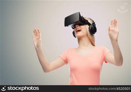 technology, virtual reality, entertainment and people concept - happy young woman with virtual reality headset or 3d glasses and headphones playing game over gray background