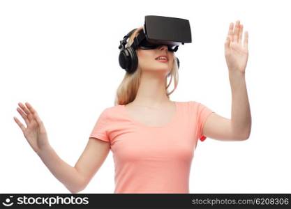 technology, virtual reality, entertainment and people concept - happy young woman with virtual reality headset or 3d glasses and headphones playing game