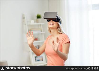 technology, virtual reality, entertainment and people concept - happy young woman with virtual reality headset or 3d glasses playing game at home and touching something invisible