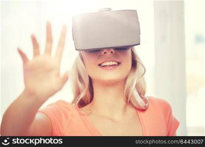 technology, virtual reality, entertainment and people concept - happy young woman with virtual reality headset or 3d glasses playing game at home and touching something invisible. woman in virtual reality headset or 3d glasses