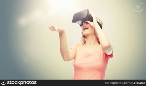 technology, virtual reality, entertainment and people concept - happy young woman with virtual reality headset or 3d glasses over gray background. woman in virtual reality headset or 3d glasses