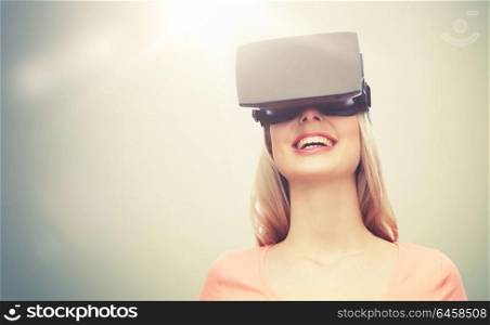 technology, virtual reality, entertainment and people concept - happy young woman with virtual reality headset or 3d glasses over gray background. woman in virtual reality headset or 3d glasses