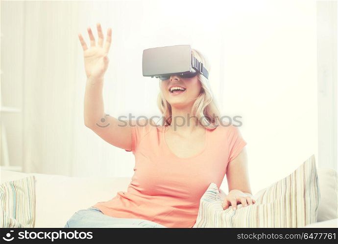 technology, virtual reality, entertainment and people concept - happy young woman with virtual reality headset or 3d glasses playing game at home and touching something invisible. woman in virtual reality headset or 3d glasses. woman in virtual reality headset or 3d glasses