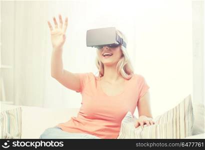 technology, virtual reality, entertainment and people concept - happy young woman with virtual reality headset or 3d glasses playing game at home and touching something invisible. woman in virtual reality headset or 3d glasses. woman in virtual reality headset or 3d glasses