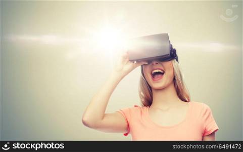technology, virtual reality, entertainment and people concept - happy young woman with virtual reality headset or 3d glasses over gray background and laser light. woman in virtual reality headset or 3d glasses. woman in virtual reality headset or 3d glasses