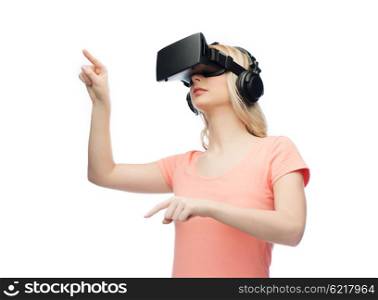 technology, virtual reality, entertainment and people concept - young woman with virtual reality headset or 3d glasses pointing to or touching something