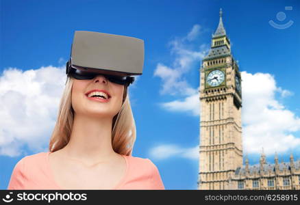 technology, virtual reality, entertainment, travel and people concept - happy young woman with virtual reality headset or 3d glasses over big ben tower and sky background