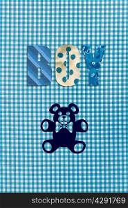Teddy bear and the word Boy on blue gingham background