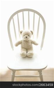 Teddy bear sat on a chair