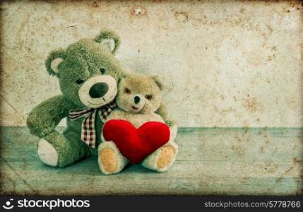 Teddy Bears couple with red heart. Valentines Day concept. Vintage style toned picture