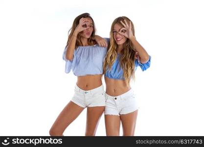 Teen best friends girls happy together looking through finger goggles