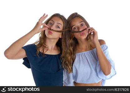Teen best friends girls having fun doing moustache with hair