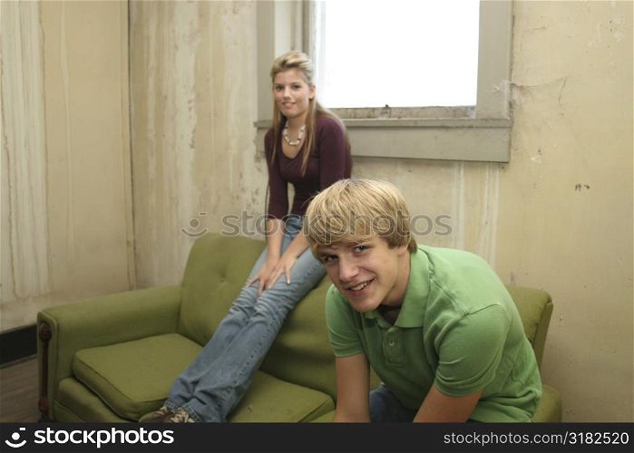 Teen boy and girl in old apartment.