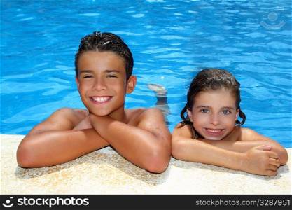 teen boy and little girl summer vacation in blue swimming pool