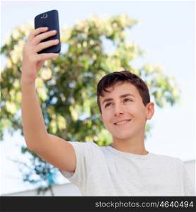 Teen boy getting a photo with the phone in the street