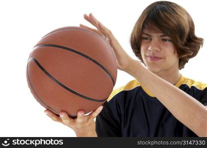 Teen Boy Holding Basket Ball Over White. Focus on basketball.