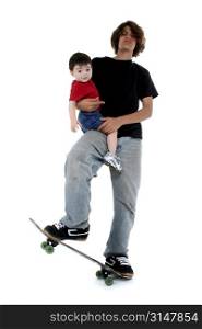 Teen boy holding toddler boy while standing on skateboard.