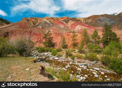 Teen boy in valley of Mars landscapes in the Altai Mountains, Kyzyl Chin, Siberia, Russia. Valley of Mars landscapes