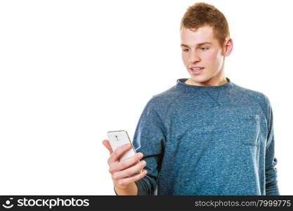 Teen boy texting on the mobile phone. Young man reading sms on smartphone, using cellphone isolated