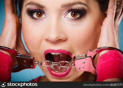 Teen crime, arrest and jail - Criminal teenager girl prisoner woman in handcuffs blue background