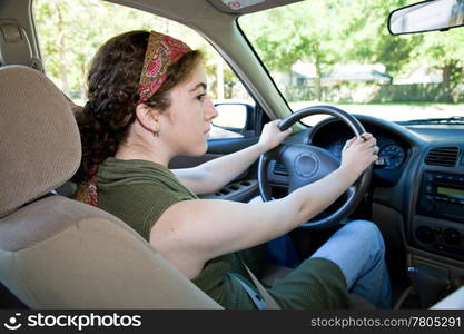 Teen driver looking both ways before pulling into the intersection.