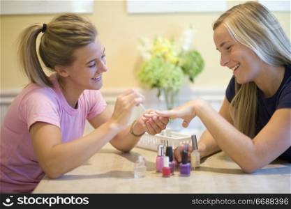 Teen friends doing manicures for each other