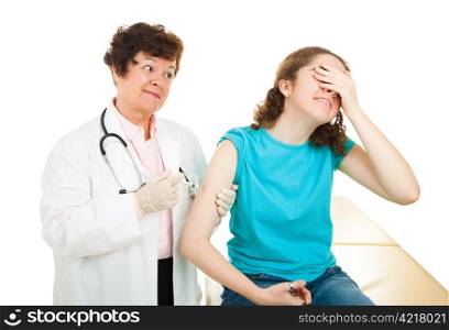 Teen girl afraid and covering her eyes as she gets a vaccination from a doctor. Isolated.