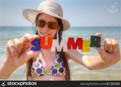 Teen girl at a beach with word Summer!