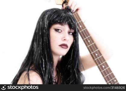 Teen girl bass player in goth fashion.