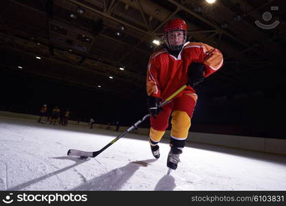 teen girl children ice hockey player in action kicking puck with stick