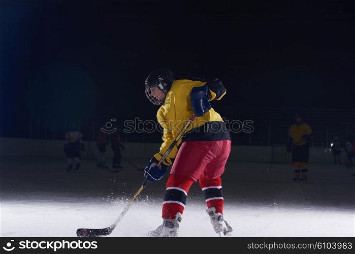 teen girl children ice hockey player in action kicking puck with stick