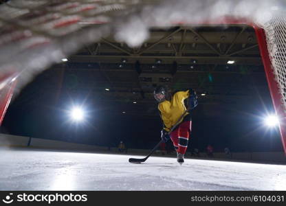 teen girl children ice hockey player in action kicking puck with stick