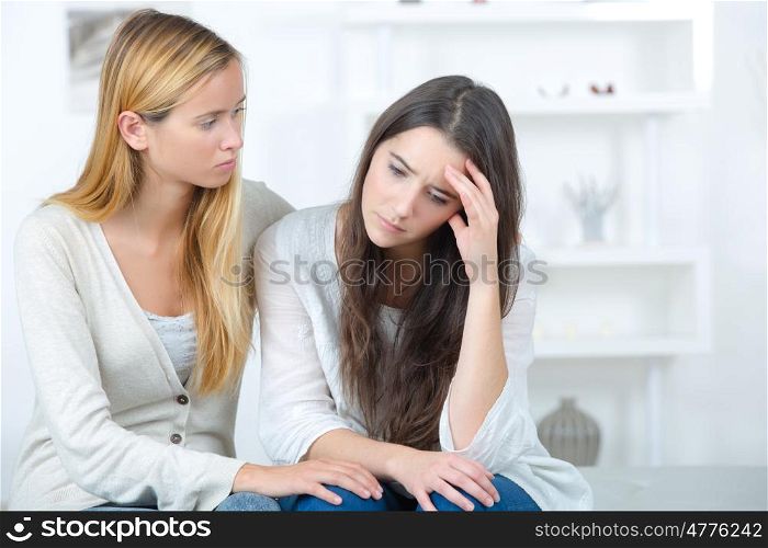 teen girl consoling her sad friend
