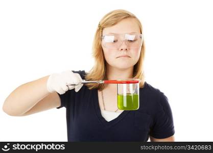 Teen girl doing chemistry, looking at a goey green substance. Isolated on white.