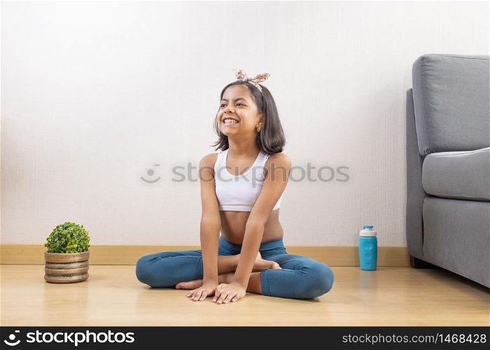 Teen girl doing yoga at home
