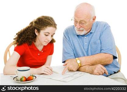 Teen girl filling out absentee ballot gets help from her grandfather. Isolated on white.