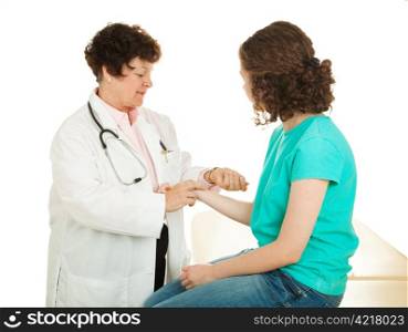 Teen girl has her pulse taken by a caring female doctor. Isolated.