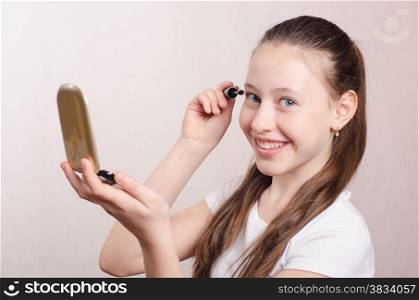 Teen girl having a fun painted cosmetics
