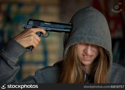 Teen girl holding a gun to your head, suicide
