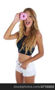 Teen girl holding donuts on her eyes as goggles at white background