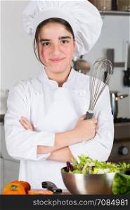 Teen girl in the kitchen preparing a salad