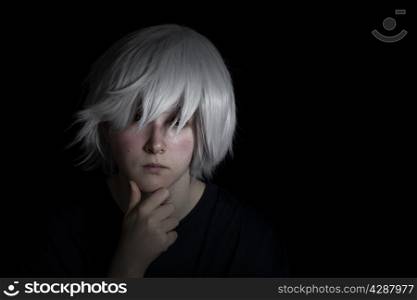 Teen girl, looking forward, wearing silver wig on black background