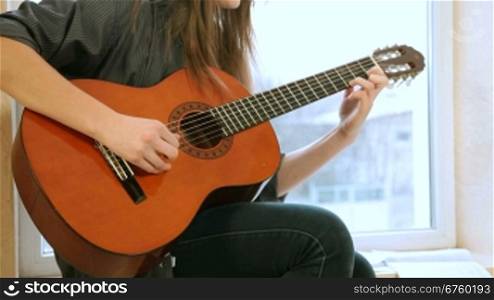 Teen Girl Playing Guitar At Home